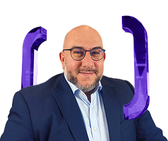 A man with glasses and a beard, dressed in a navy blazer and light blue shirt, is smiling. Purple bracket symbols are positioned behind him on both sides. The background is white.