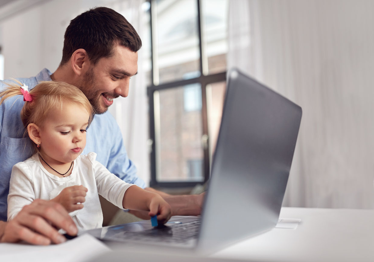 Father and daughter in front of laptop