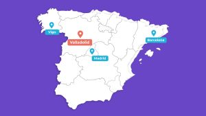 Map of spain highlighting locations with colored pins: vigo, valladolid, madrid, and barcelona on a purple background.