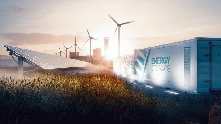 A scenic view of a renewable energy facility at sunset, featuring solar panels and wind turbines. In the foreground, an energy storage container is visible. The scene is bathed in warm, glowing light.