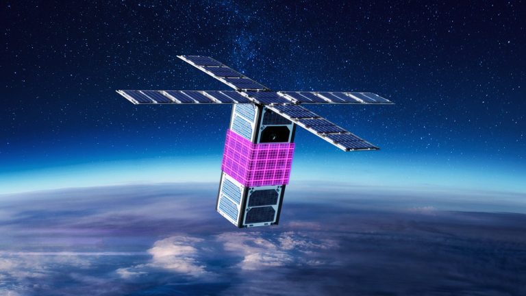 A cube satellite with extended solar panels and a pink central module orbits above Earth's atmosphere against a backdrop of space. The horizon shows the curve of the planet and wispy clouds.