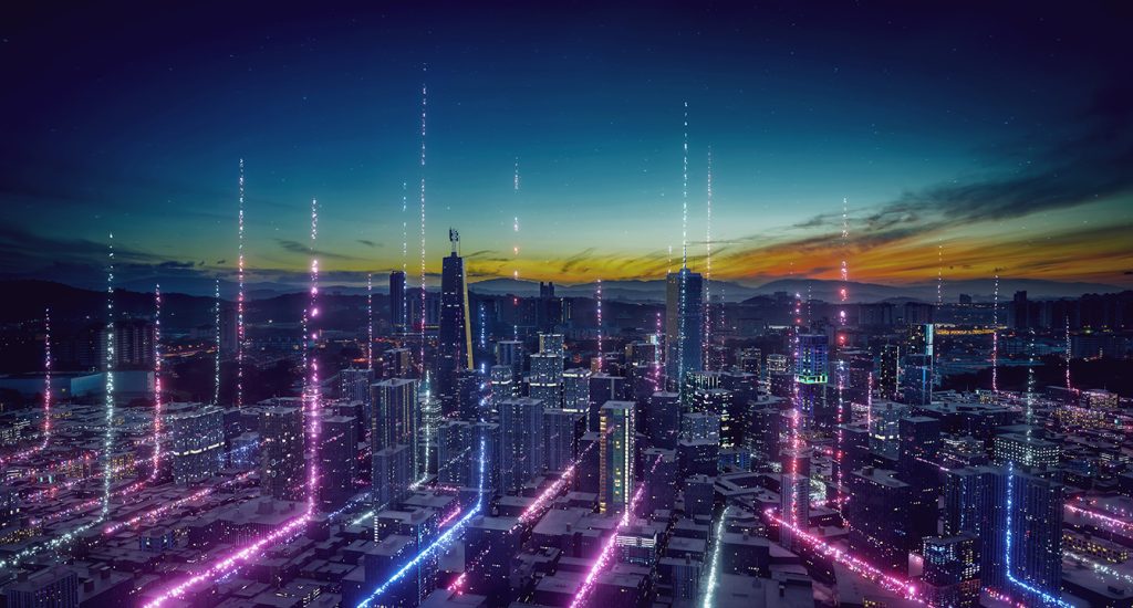 A futuristic city skyline at dusk with tall buildings illuminated by vertical neon lights and digital effects, creating a high-tech, sci-fi atmosphere against a colorful sunset sky.