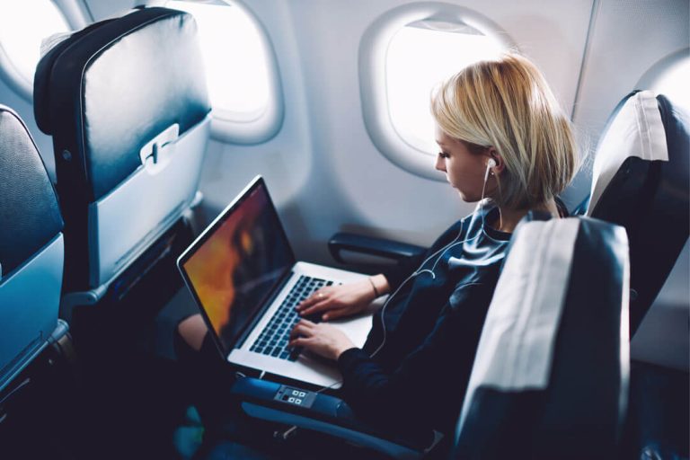 Woman on plane with laptop