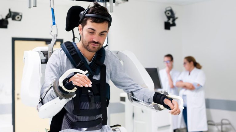 Men in a mind-controlled exoskeleton to regain mobility