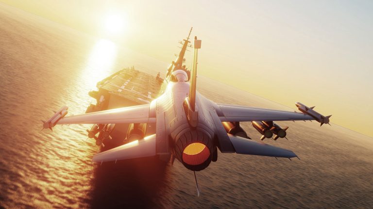 A jet fighter prepares to take off from an aircraft carrier at sea during sunset, with the sun low on the horizon and light reflecting off the water and the aircraft.