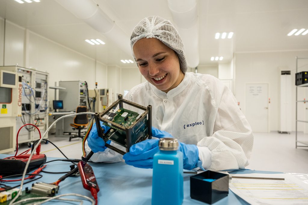 Expleo engineer works on nanosatellite in clean room