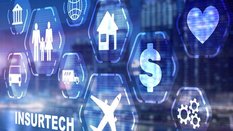 A digital display featuring various icons representing different insurance sectors like health, property, life, auto, and travel. The text "INSURTECH" appears on the left. The background shows a blurred cityscape with illuminated buildings at night