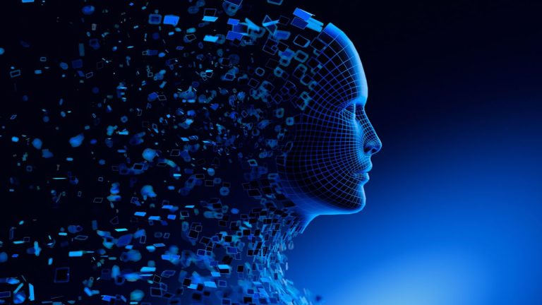 A digital human face made of blue wireframe and geometric shapes dissolves into scattered fragments, set against a dark blue background, symbolizing artificial intelligence and technology.