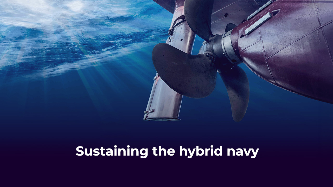 A close-up of a ship’s propeller underwater with sunlight streaming through, and the text “Sustaining the hybrid navy” displayed at the bottom.
