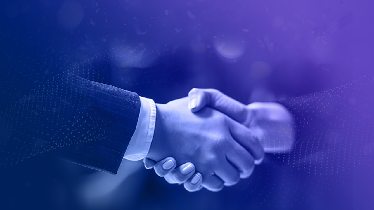 Two people wearing business attire shaking hands, set against a purple and blue gradient background. The image suggests a professional agreement or partnership.