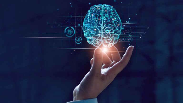 A hand reaches toward a glowing digital brain with circuit-like patterns and AI text, symbolizing artificial intelligence and advanced technology, against a dark blue background.