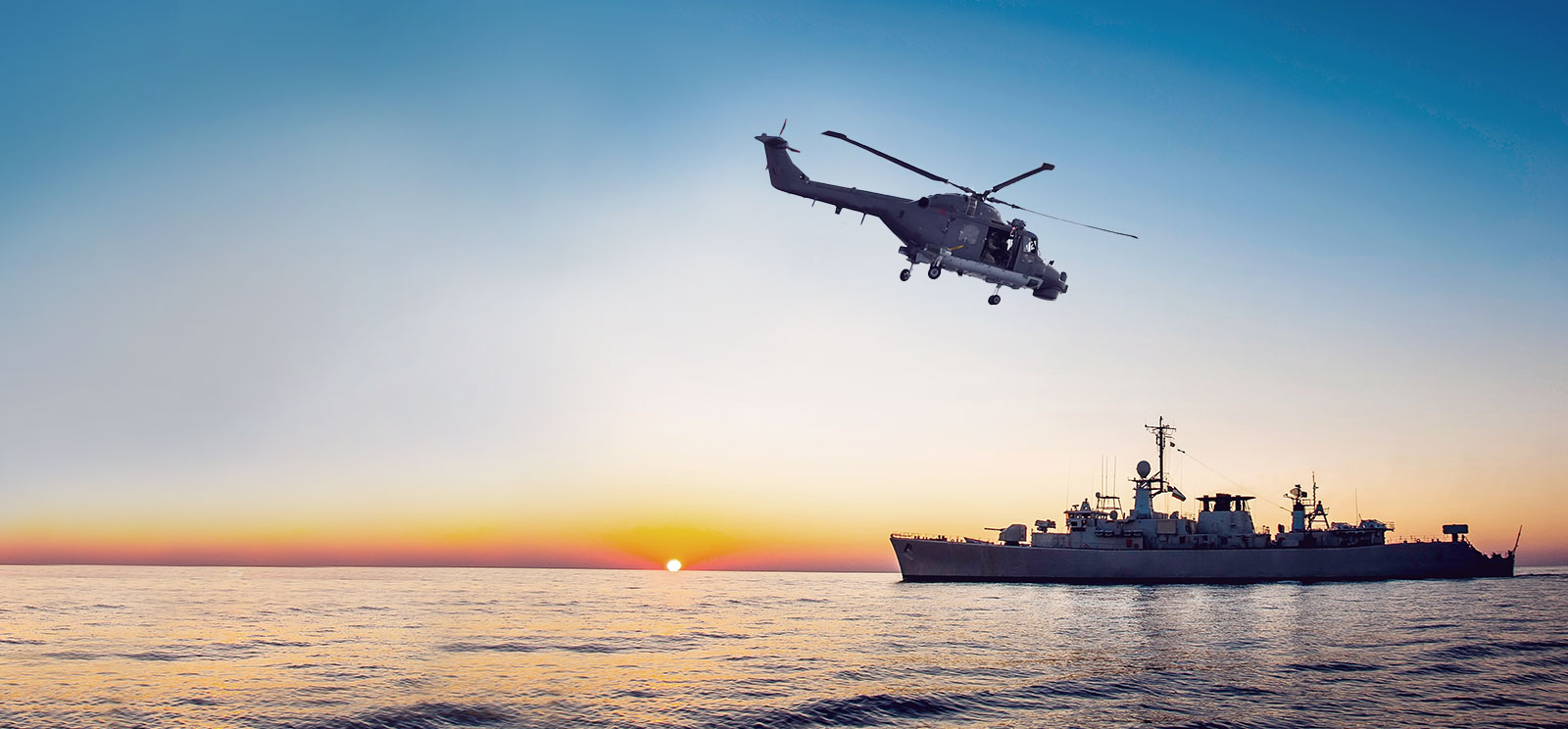 Helicopter approaching combat ship