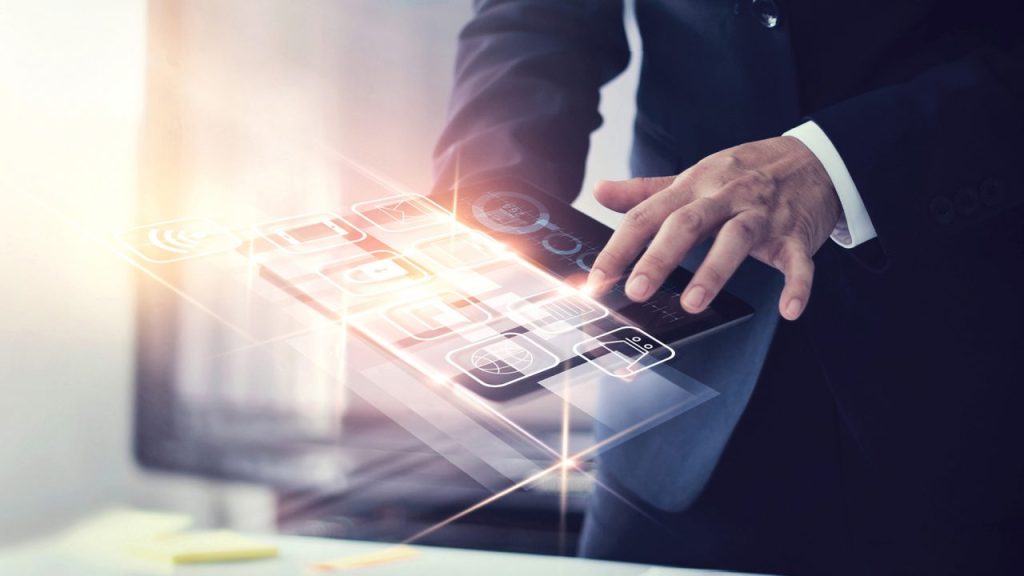 A man holding a tablet with virtual icons