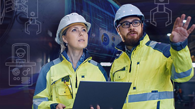 Two engineers wearing yellow safety jackets and white hard hats stand in an industrial setting. One holds a laptop, while the other points towards something off-frame. Behind them, there are futuristic graphical overlays symbolizing technology and machinery.