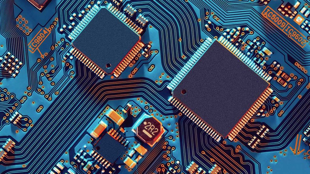 A close-up image of a blue circuit board with intricate patterns of copper pathways, showcasing multiple microchips and electronic components. The highlight and shadow effects give it a metallic and futuristic appearance.
