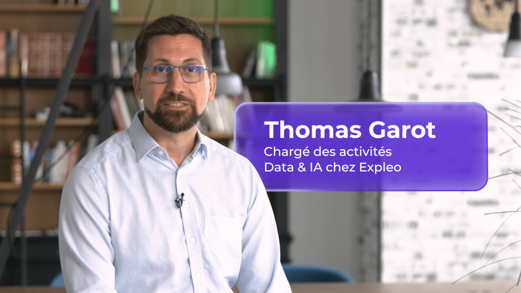 A man with glasses and a beard sits indoors with bookshelves in the background. A purple text box reads: "Thomas Garot, Chargé des activités Data & IA chez Expleo.