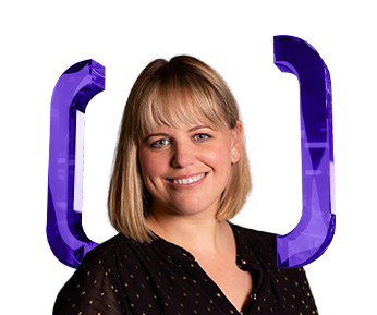 A woman with blonde hair and bangs, wearing a black shirt with gold dots, smiles in front of two large, purple, three-dimensional bracket symbols on a white background.